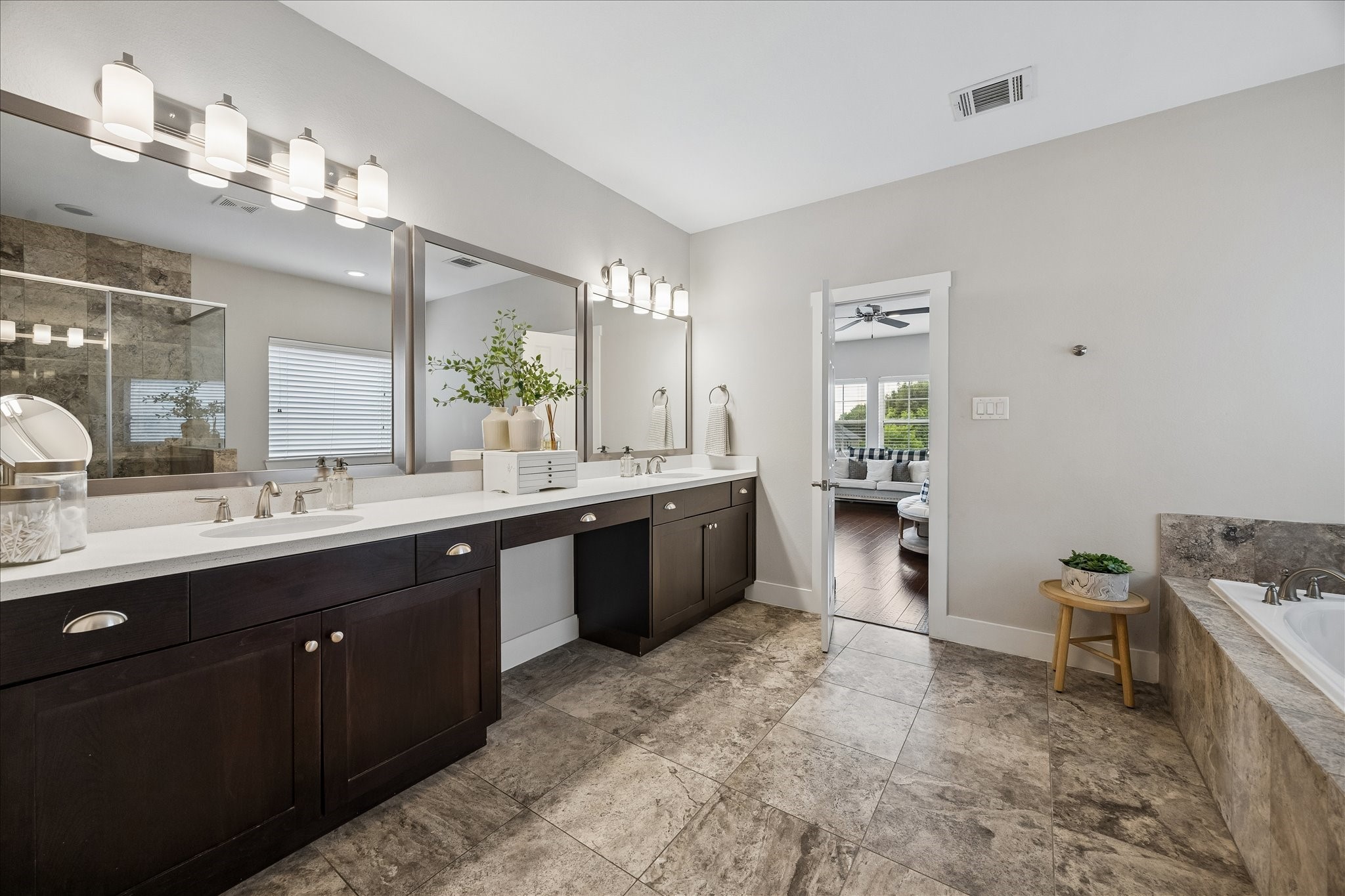 2416 Couch Street Houston, TX 77008 - Photo 27 of 34 a large bathroom with a double vanity sink a toilet a mirror and shower