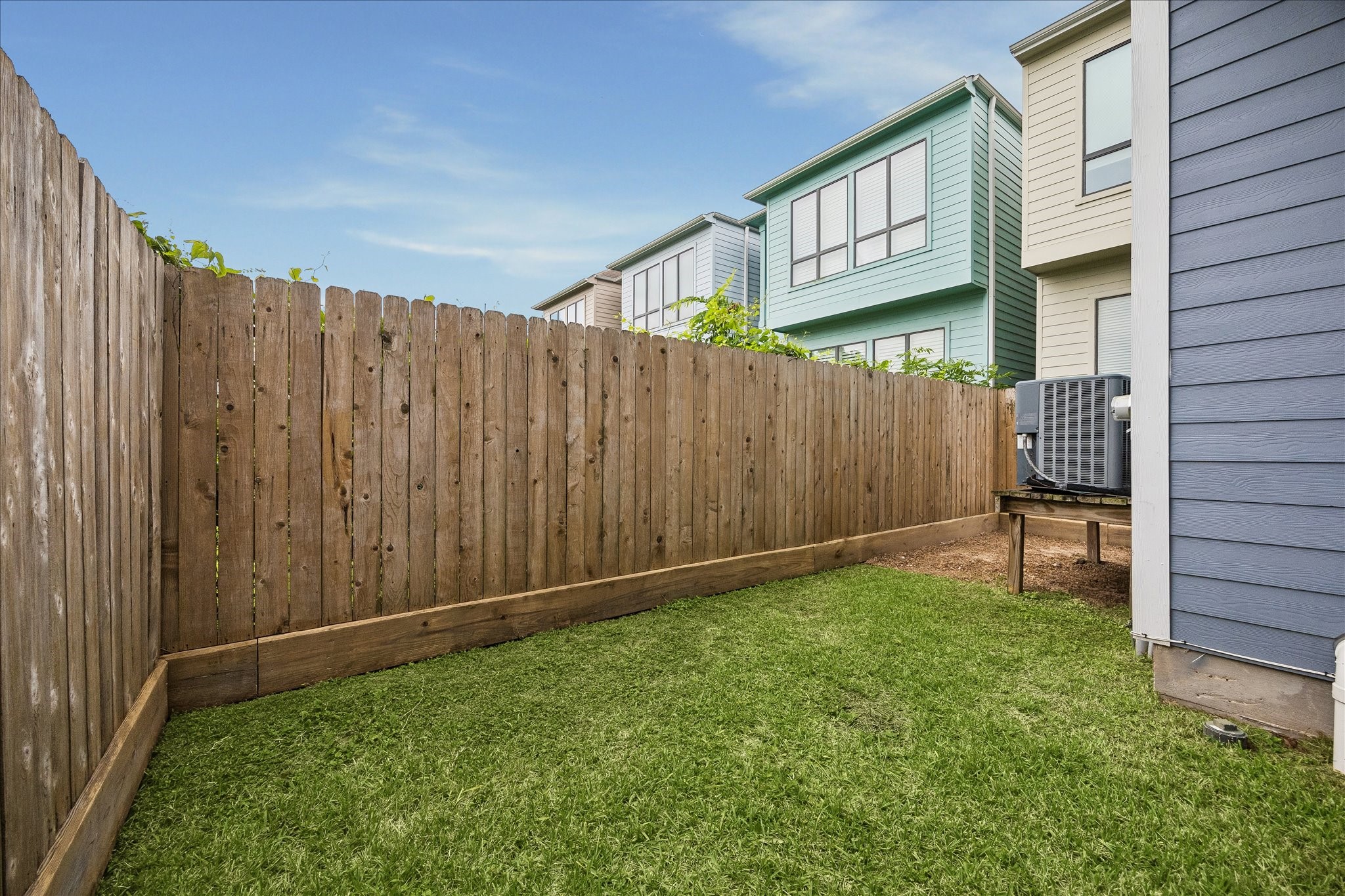2416 Couch Street Houston, TX 77008 - Photo 32 of 34 a view of backyard with potted plants and wooden fence