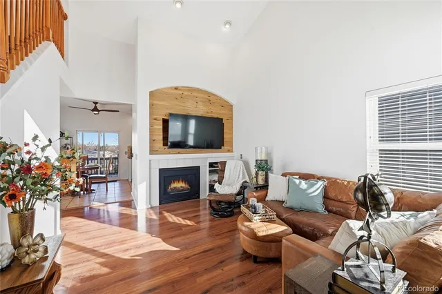 a living room with furniture a fireplace and a flat screen tv