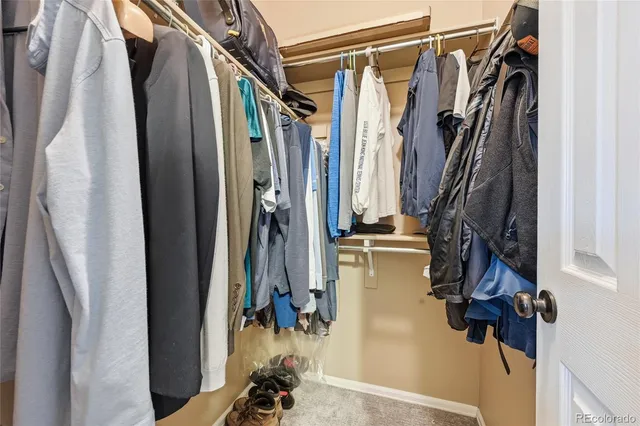 a view of walk in closet with clothes