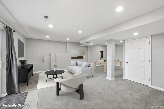 a living room with furniture and a rug