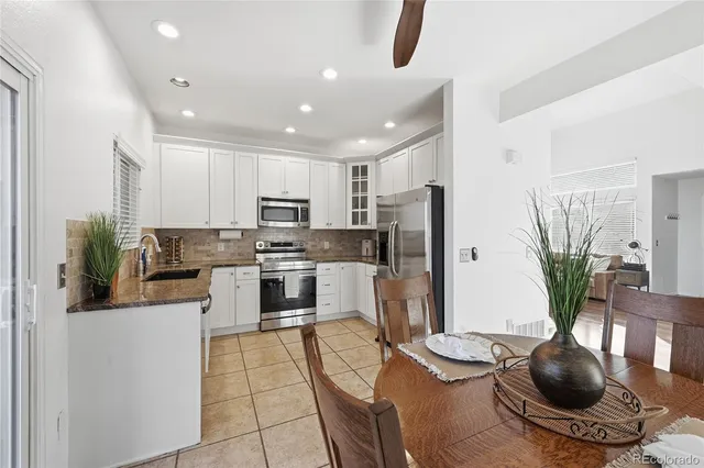 a kitchen with stainless steel appliances granite countertop a refrigerator and a stove top oven