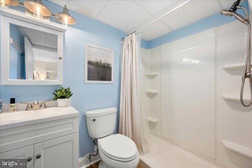 11 134th Street, Unit 205 Ocean City, MD 21842 - Photo 17 of 29 a bathroom with a sink a toilet a mirror and shower