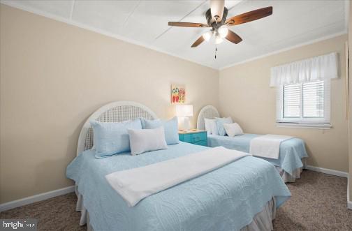 11 134th Street, Unit 205 Ocean City, MD 21842 - Photo 18 of 29 a bedroom with two beds and a chandelier