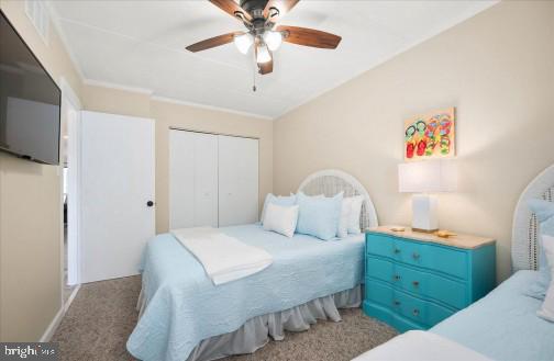 11 134th Street, Unit 205 Ocean City, MD 21842 - Photo 19 of 29 a bedroom with a bed and a chandelier