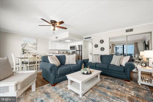 11 134th Street, Unit 205 Ocean City, MD 21842 - Photo 3 of 29 a living room with furniture a rug and a chandelier