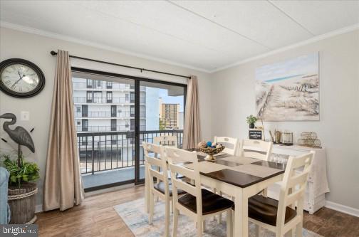 11 134th Street, Unit 205 Ocean City, MD 21842 - Photo 6 of 29 a view of a dining room with furniture and a potted plant