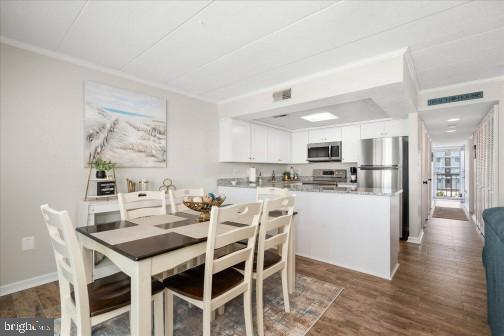 11 134th Street, Unit 205 Ocean City, MD 21842 - Photo 7 of 29 a view of a dining room with furniture and wooden floor