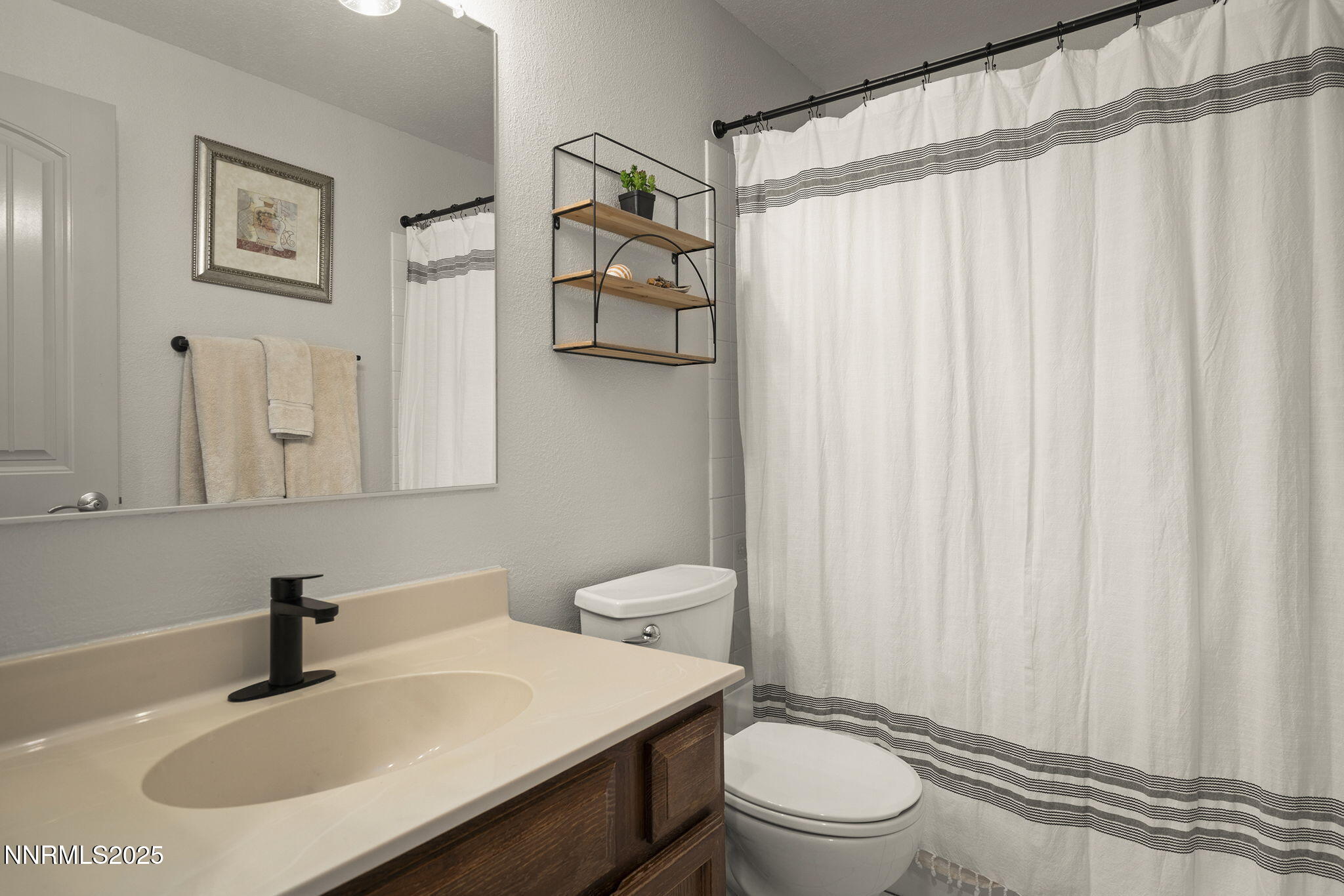 1080 Tudor Court Reno, NV 89503 - Photo 15 of 30 a bathroom with a sink a toilet and shower curtain