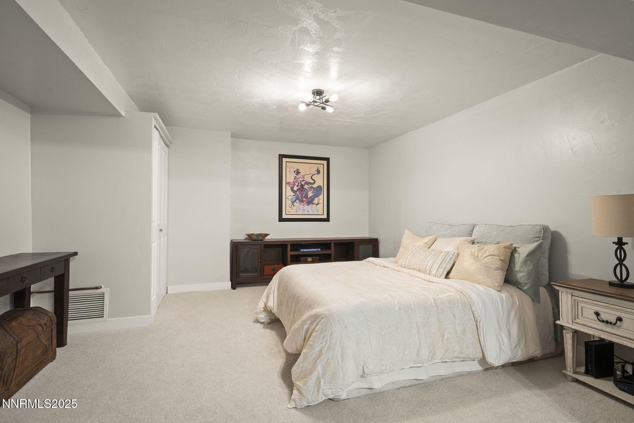 1080 Tudor Court Reno, NV 89503 - Photo 18 of 30 a bedroom with a bed and a chandelier