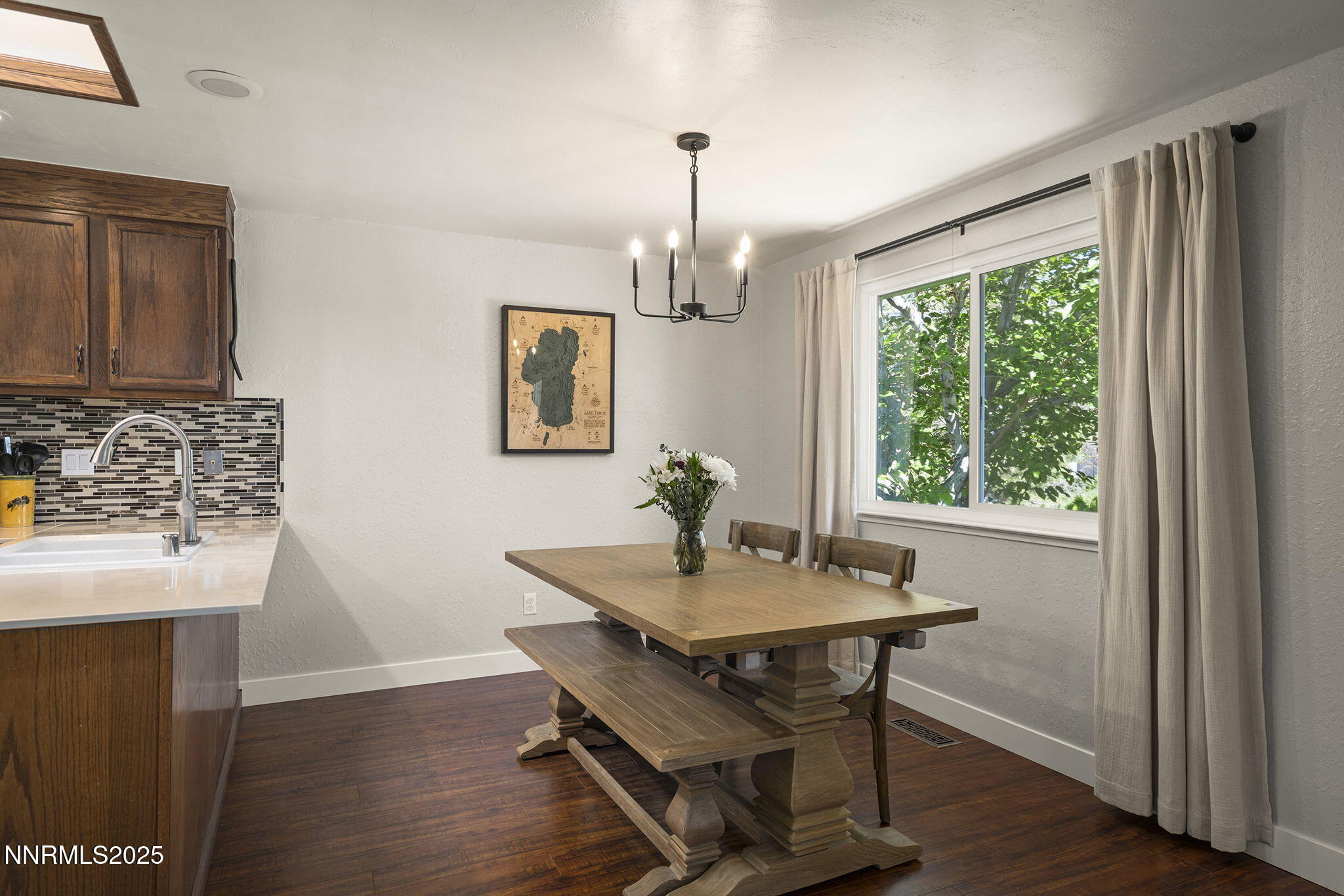 1080 Tudor Court Reno, NV 89503 - Photo 10 of 30 a dining room with wooden floor a chandelier a wooden table and chairs