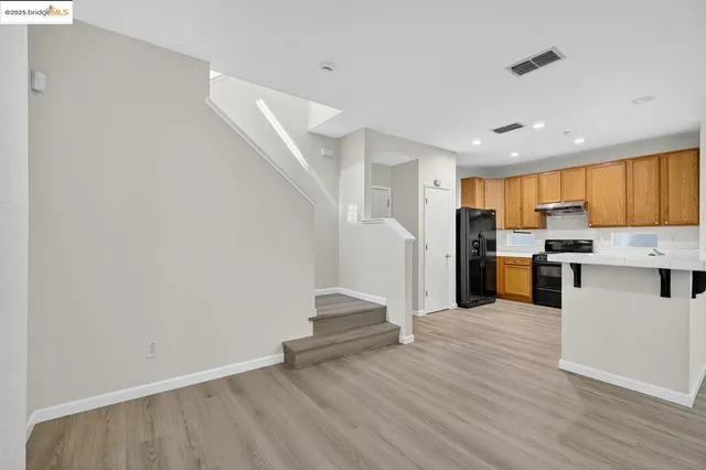 a view of kitchen with wooden floor and electronic appliances
