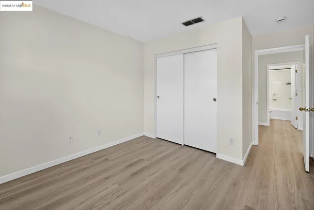 a view of a room with wooden floor