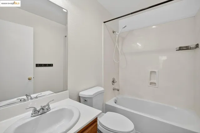 a bathroom with a sink toilet tub and shower