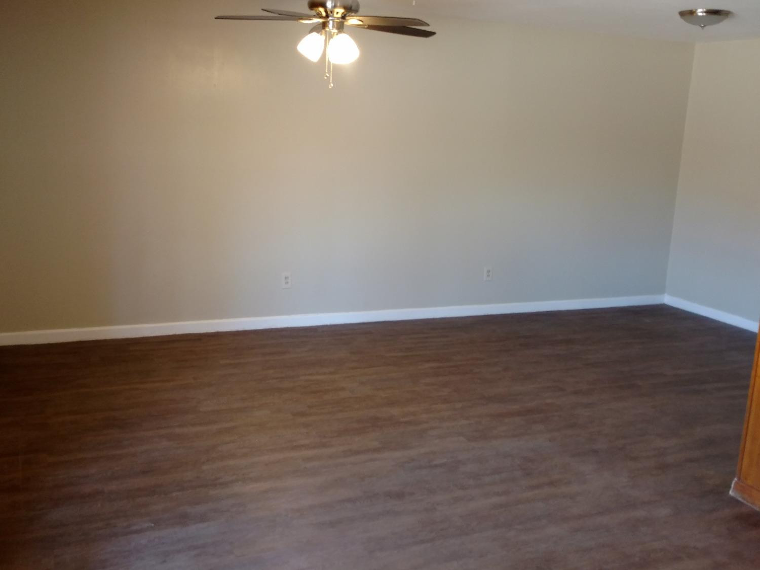 2812 43rd Street, Unit 6 Lubbock, TX 79413 - Photo 5 of 10 a view of an empty room with wooden floor