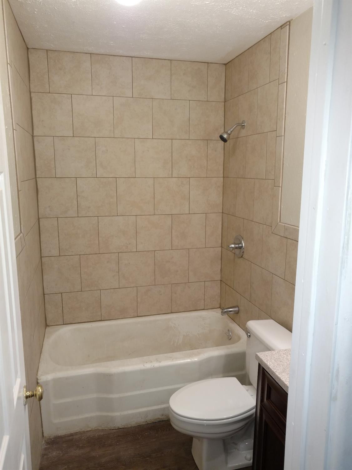 2812 43rd Street, Unit 6 Lubbock, TX 79413 - Photo 9 of 10 a bathroom with a toilet and a bathtub