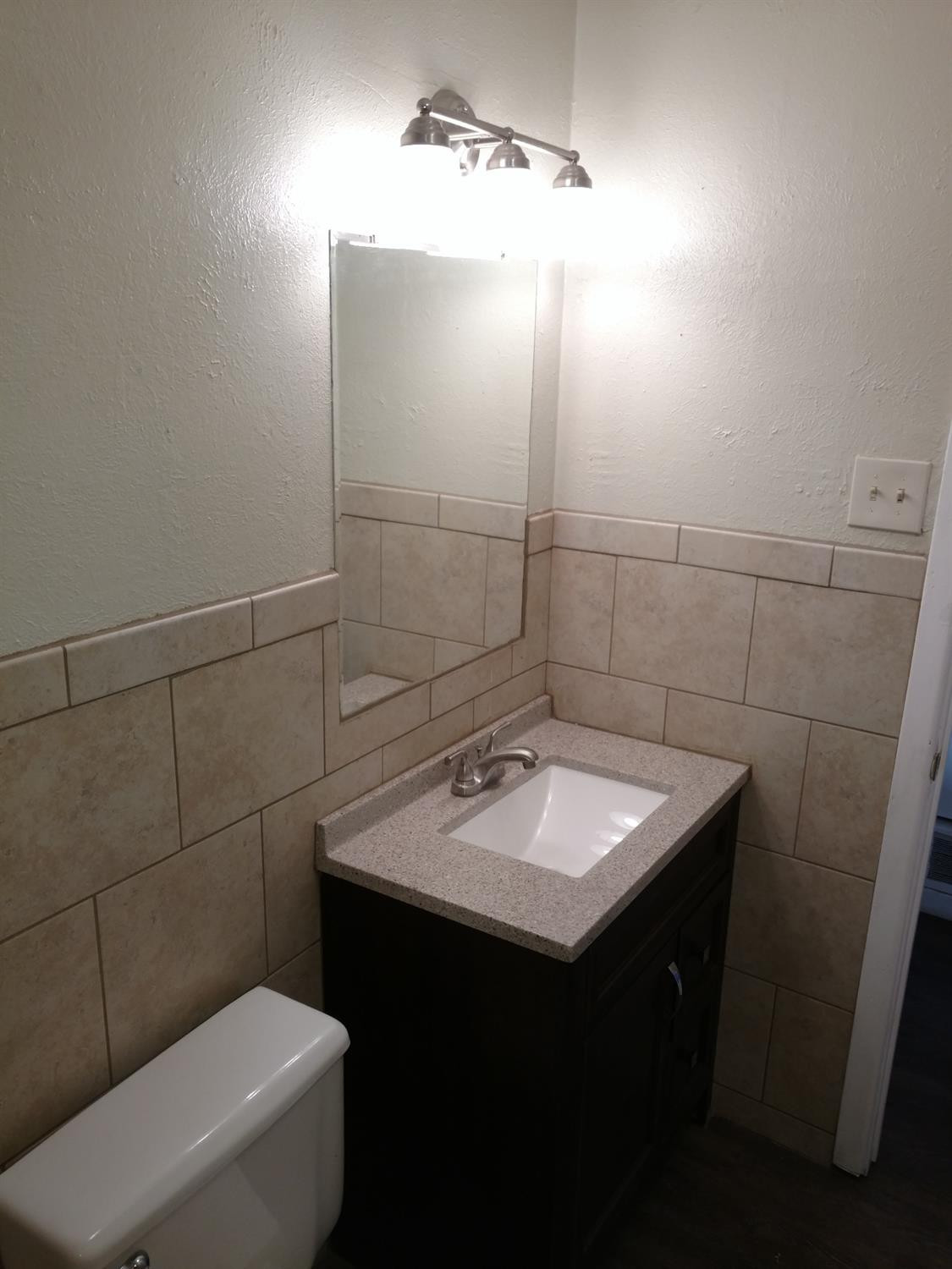 2812 43rd Street, Unit 6 Lubbock, TX 79413 - Photo 10 of 10 a bathroom with a sink toilet and vanity
