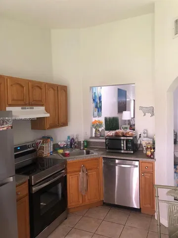 a kitchen with a sink a stove and cabinets