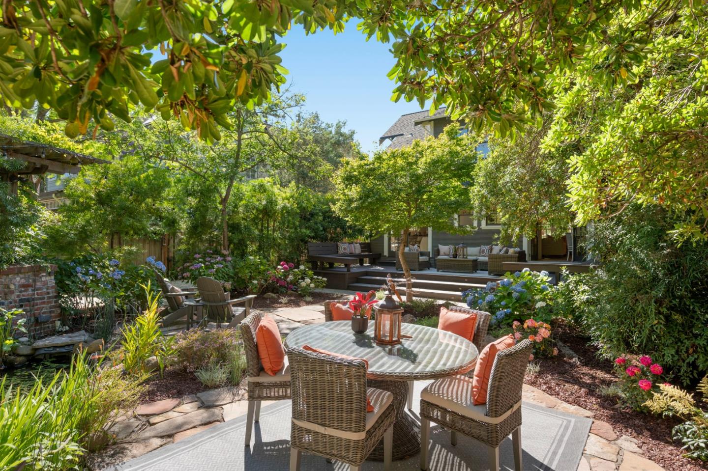 445 Arlington Road Redwood City, CA 94062 - Photo 29 of 50 a backyard of a house with table and chairs large trees