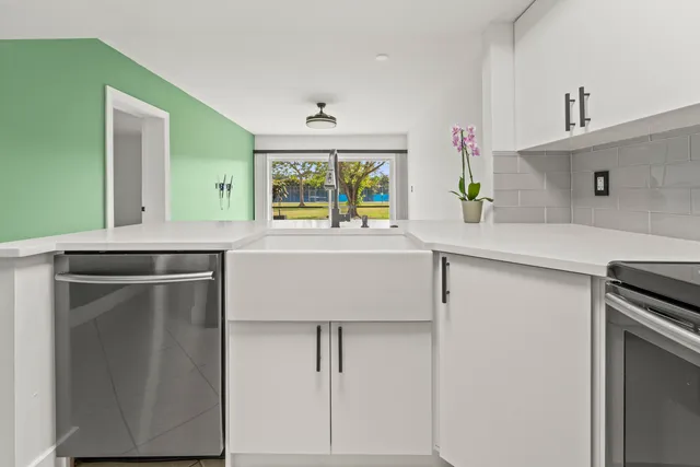 a kitchen with appliances cabinets and a sink