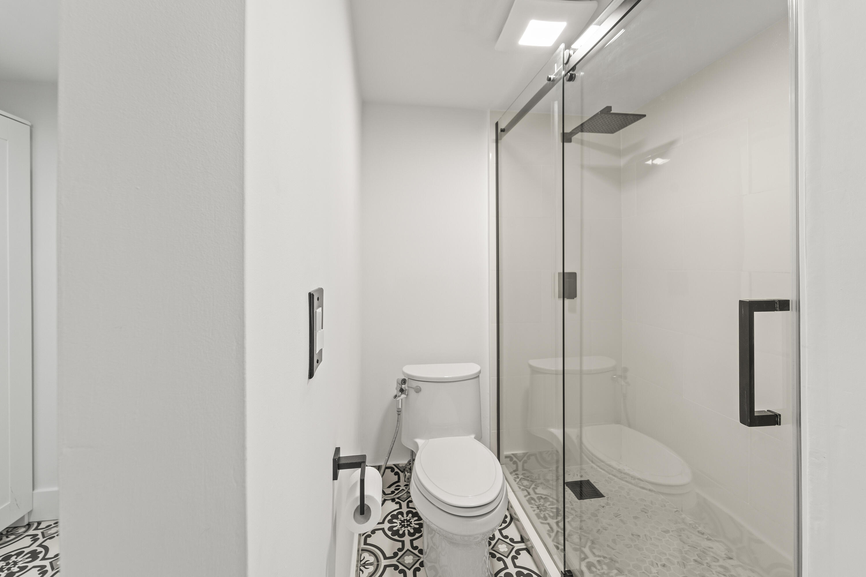 9500 Southwest 3rd Street, Unit 130 Boca Raton, FL 33428 - Photo 19 of 38 a bathroom with a toilet and a shower