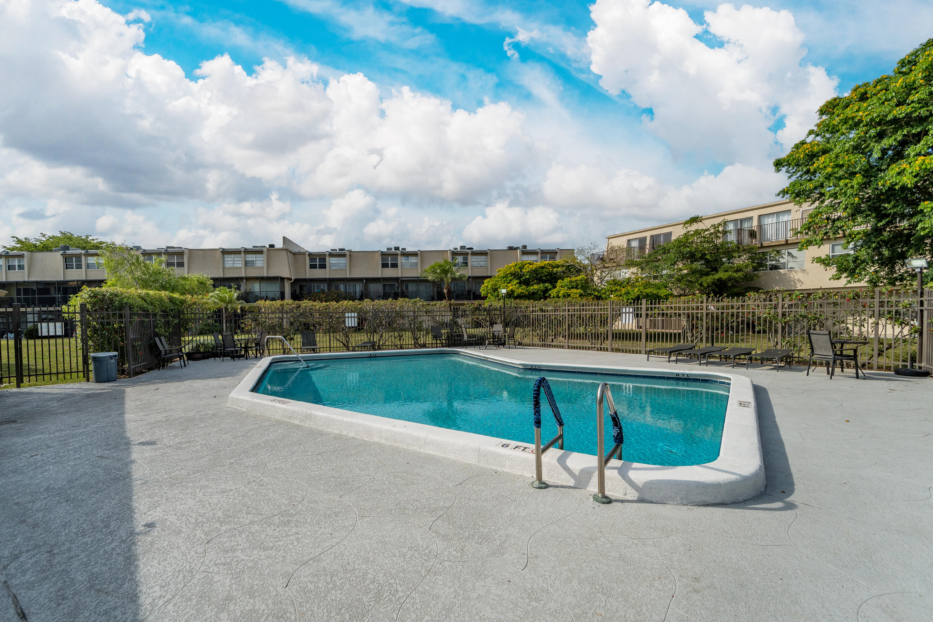 9500 Southwest 3rd Street, Unit 130 Boca Raton, FL 33428 - Photo 32 of 38 a swimming pool with outdoor seating and barbeque oven