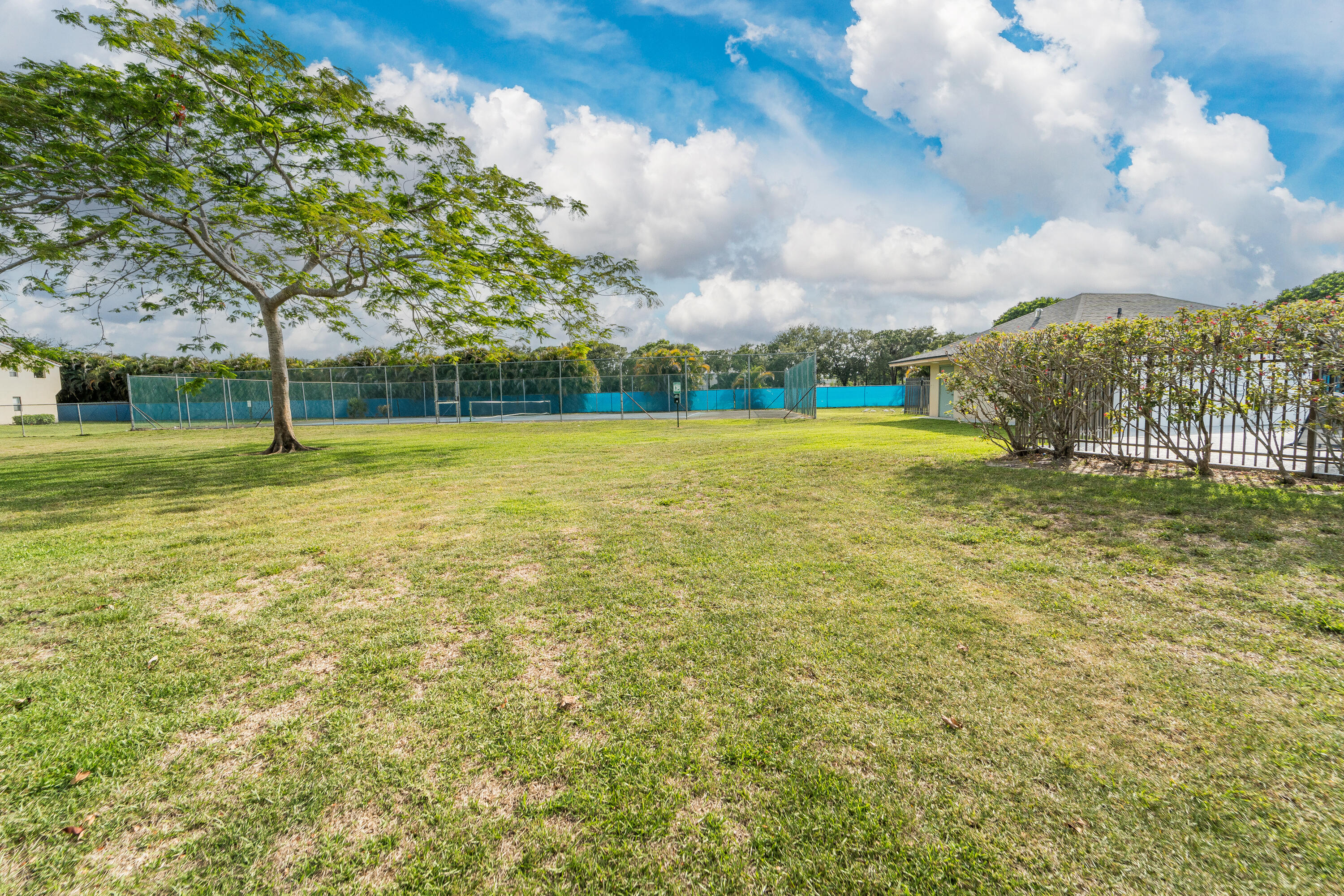 9500 Southwest 3rd Street, Unit 130 Boca Raton, FL 33428 - Photo 34 of 38 a view of a big yard with a fountain
