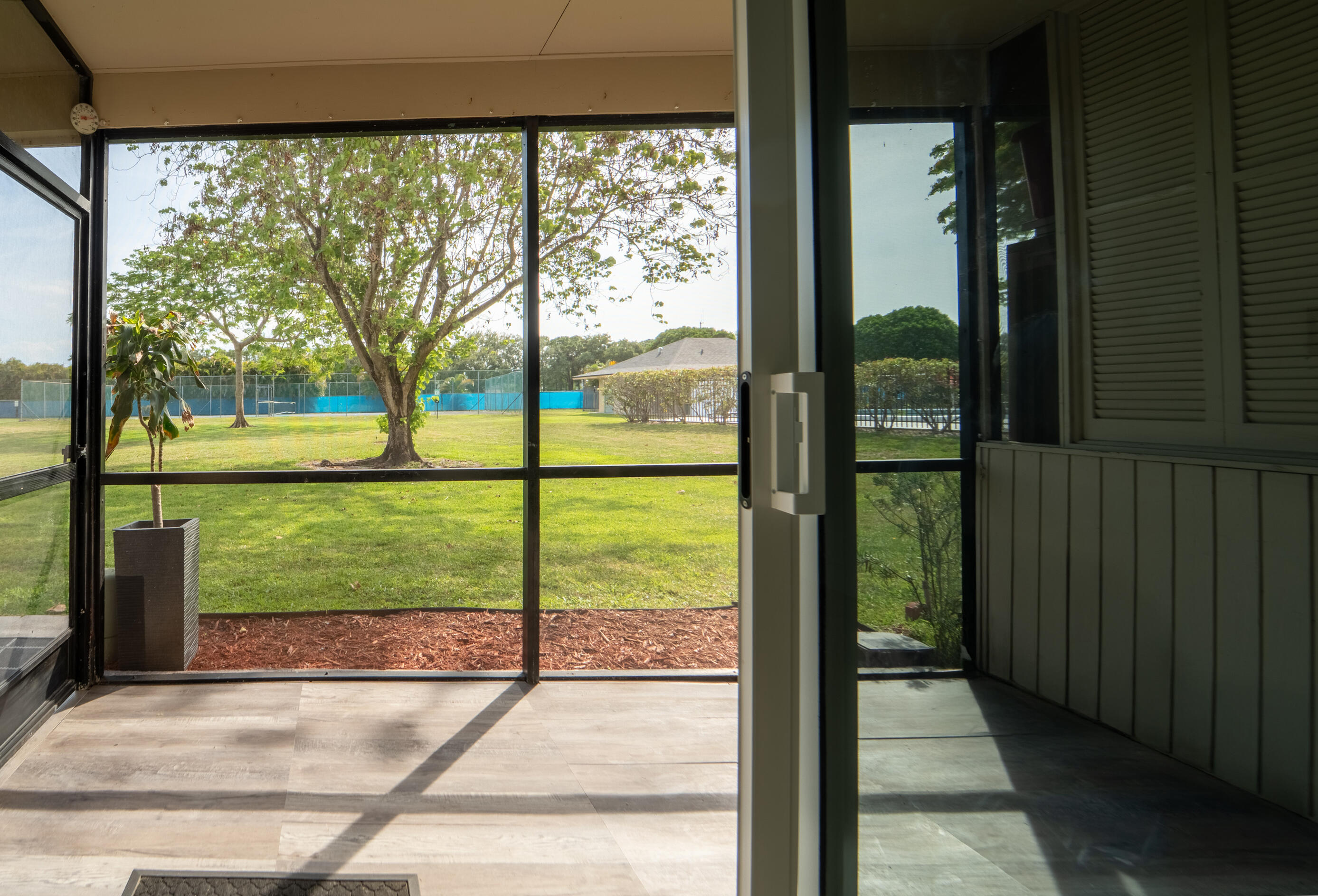 9500 Southwest 3rd Street, Unit 130 Boca Raton, FL 33428 - Photo 36 of 38 a view of porch with a floor to ceiling window next to a yard