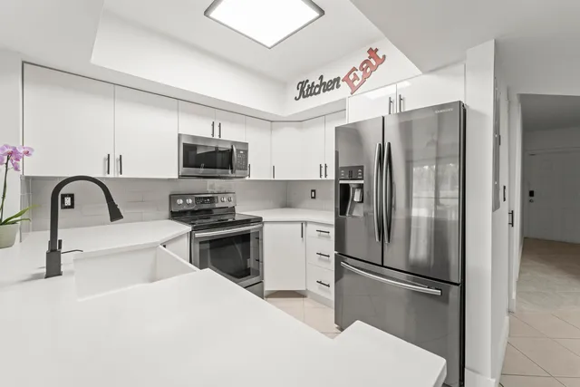 a kitchen with stainless steel appliances a refrigerator stove and a sink