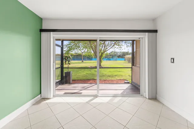 a view of a room with wooden floor and a porch