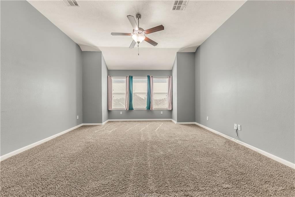 4159 Shallow Creek Loop College Station, TX 77845 - Photo 15 of 32 an empty room with chandelier fan and windows