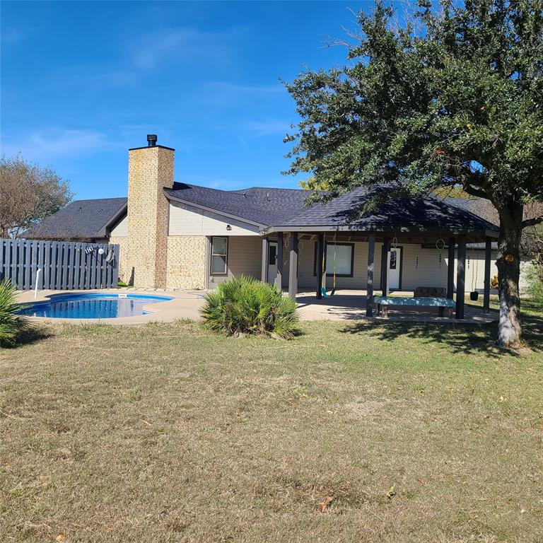 406 Epps Road Palmer, TX 75152 - Photo 25 of 36 a backyard of a house with yard and outdoor seating