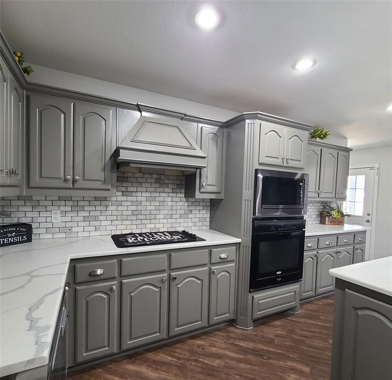 406 Epps Road Palmer, TX 75152 - Photo 6 of 36 a kitchen with stainless steel appliances granite countertop a stove and a sink