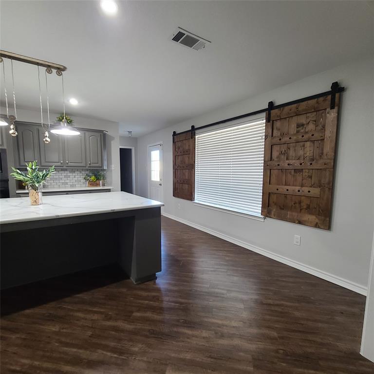 406 Epps Road Palmer, TX 75152 - Photo 7 of 36 a large kitchen with kitchen island a sink wooden floor and a fireplace