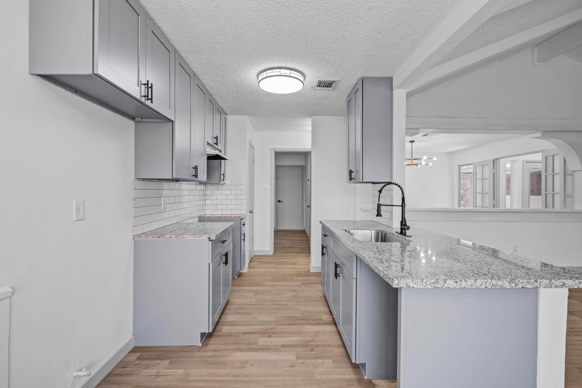 13747 Rampchester Lane Houston, TX 77015 - Photo 12 of 24 a large kitchen with a sink and cabinets