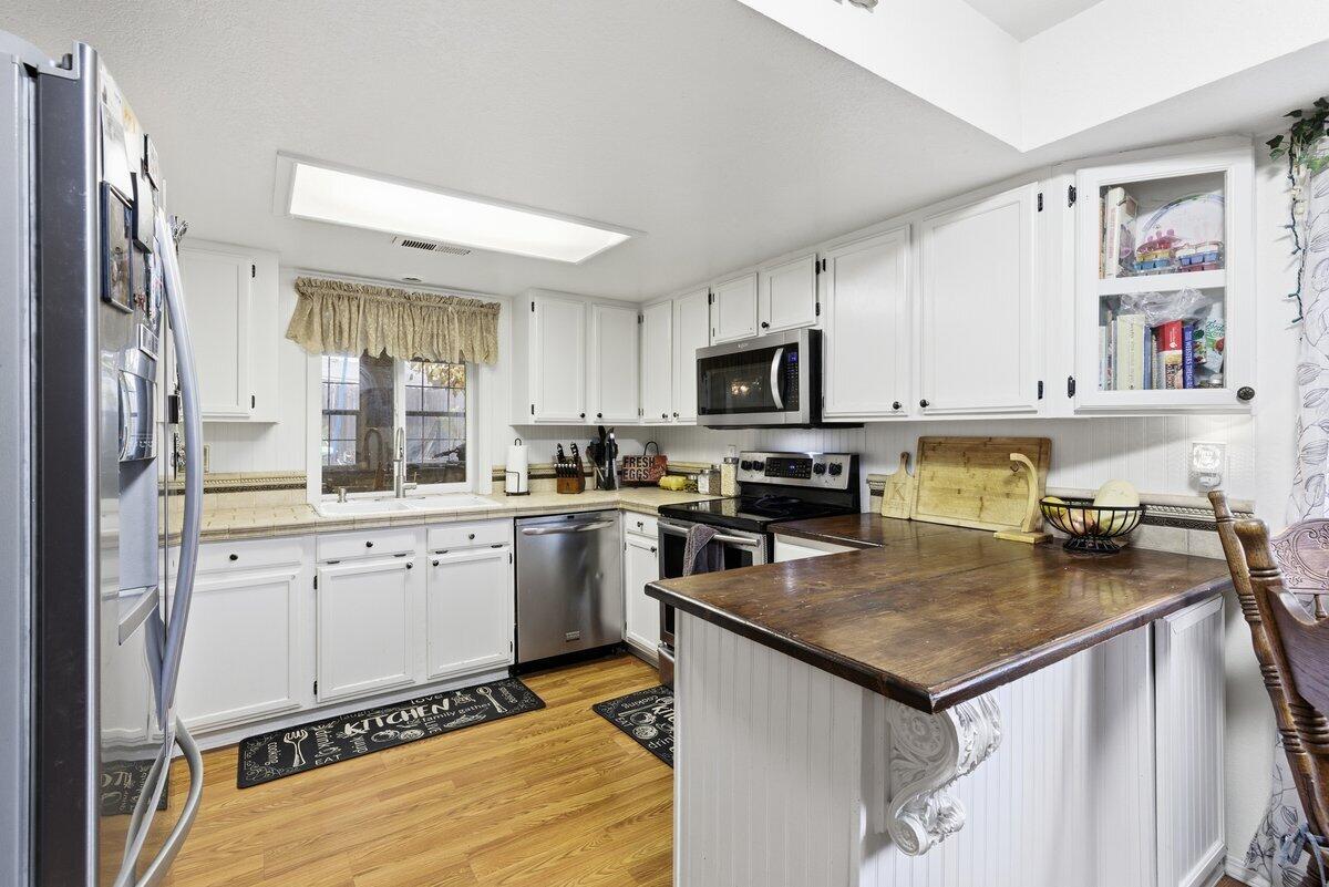 650 Sarah Lane Eagle Point, OR 97524 - Photo 9 of 19 a kitchen with a stove a sink and a refrigerator
