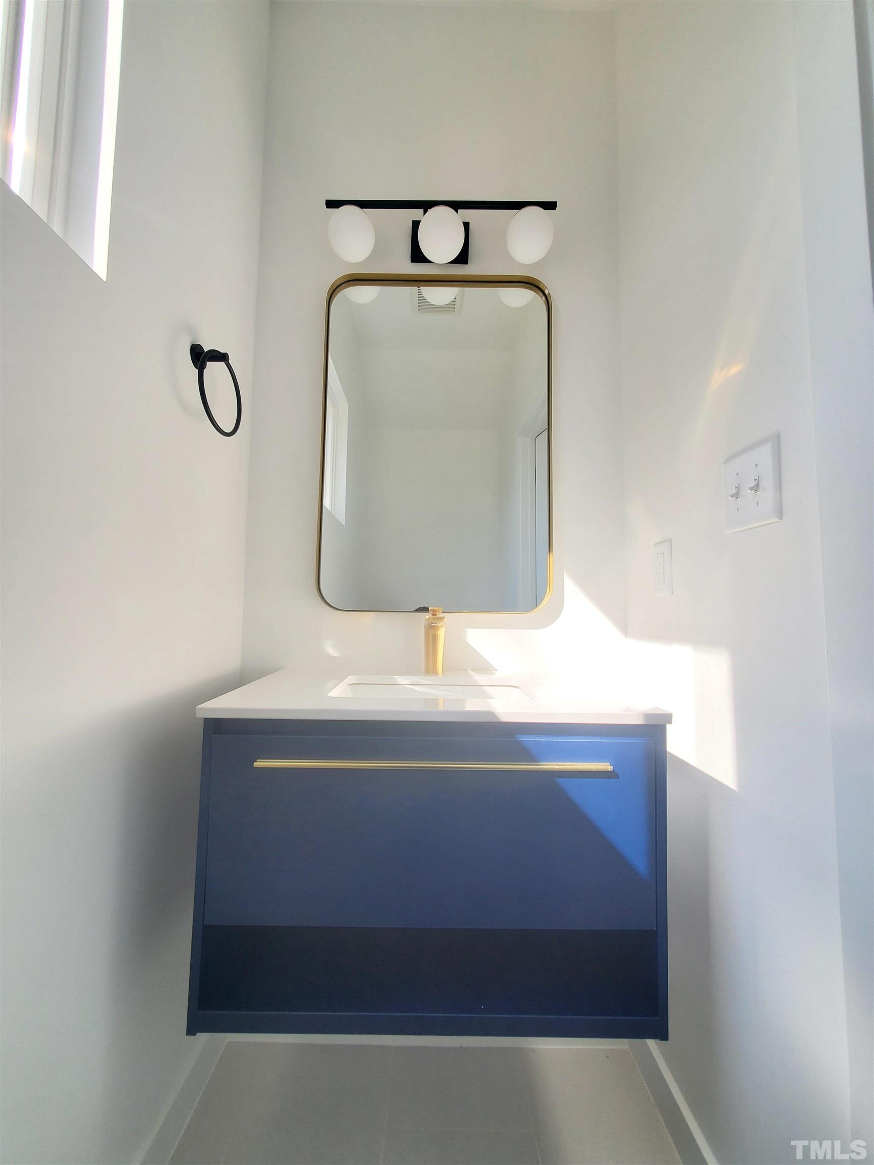 221 Bledsoe Avenue Raleigh, NC 27601 - Photo 14 of 28 a bathroom with a sink and a mirror