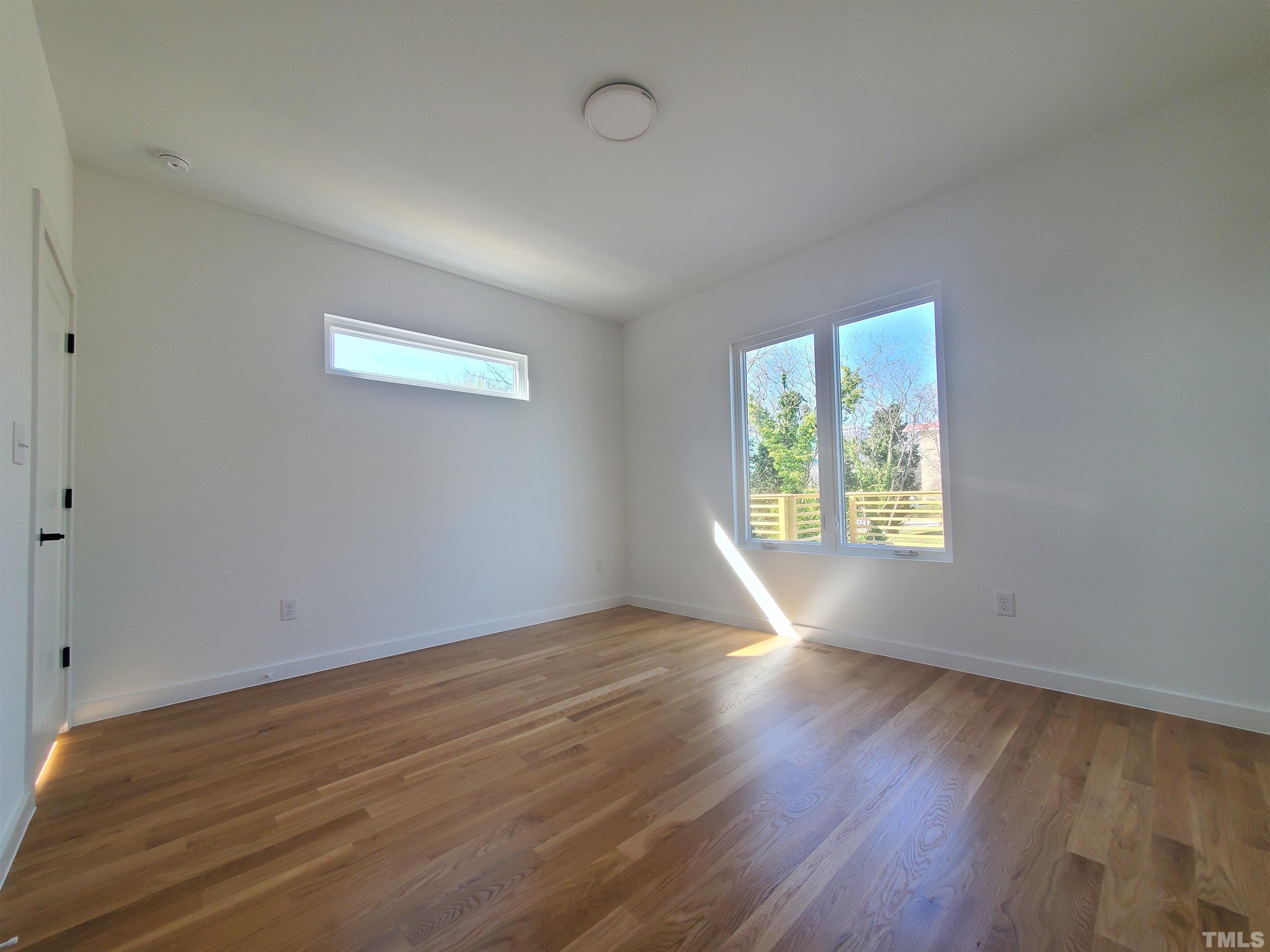221 Bledsoe Avenue Raleigh, NC 27601 - Photo 17 of 28 an empty room with wooden floor and windows