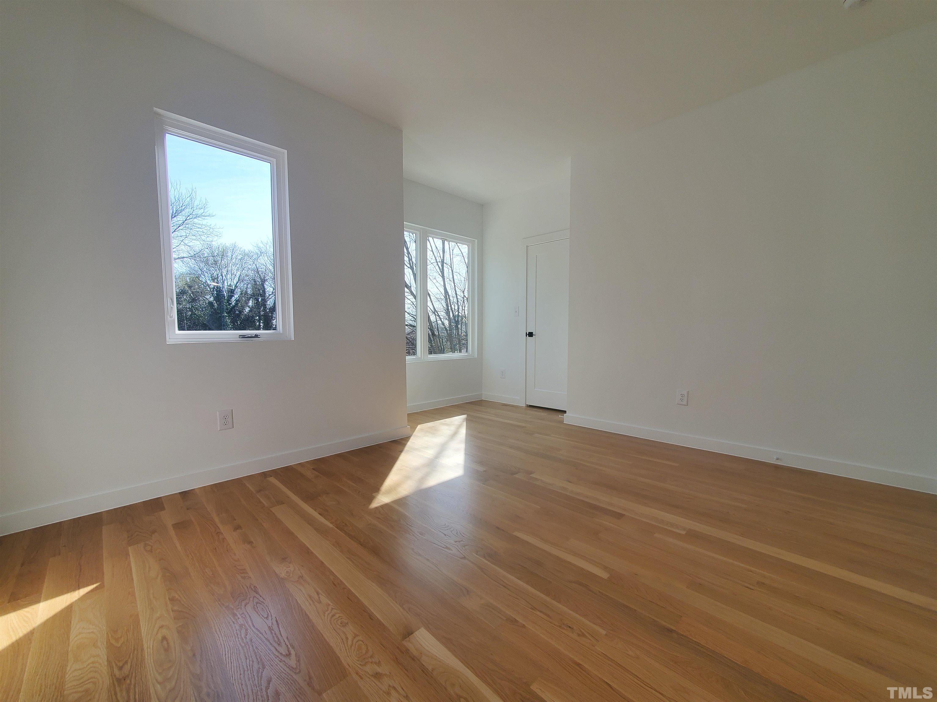 221 Bledsoe Avenue Raleigh, NC 27601 - Photo 20 of 28 an empty room with wooden floor and windows