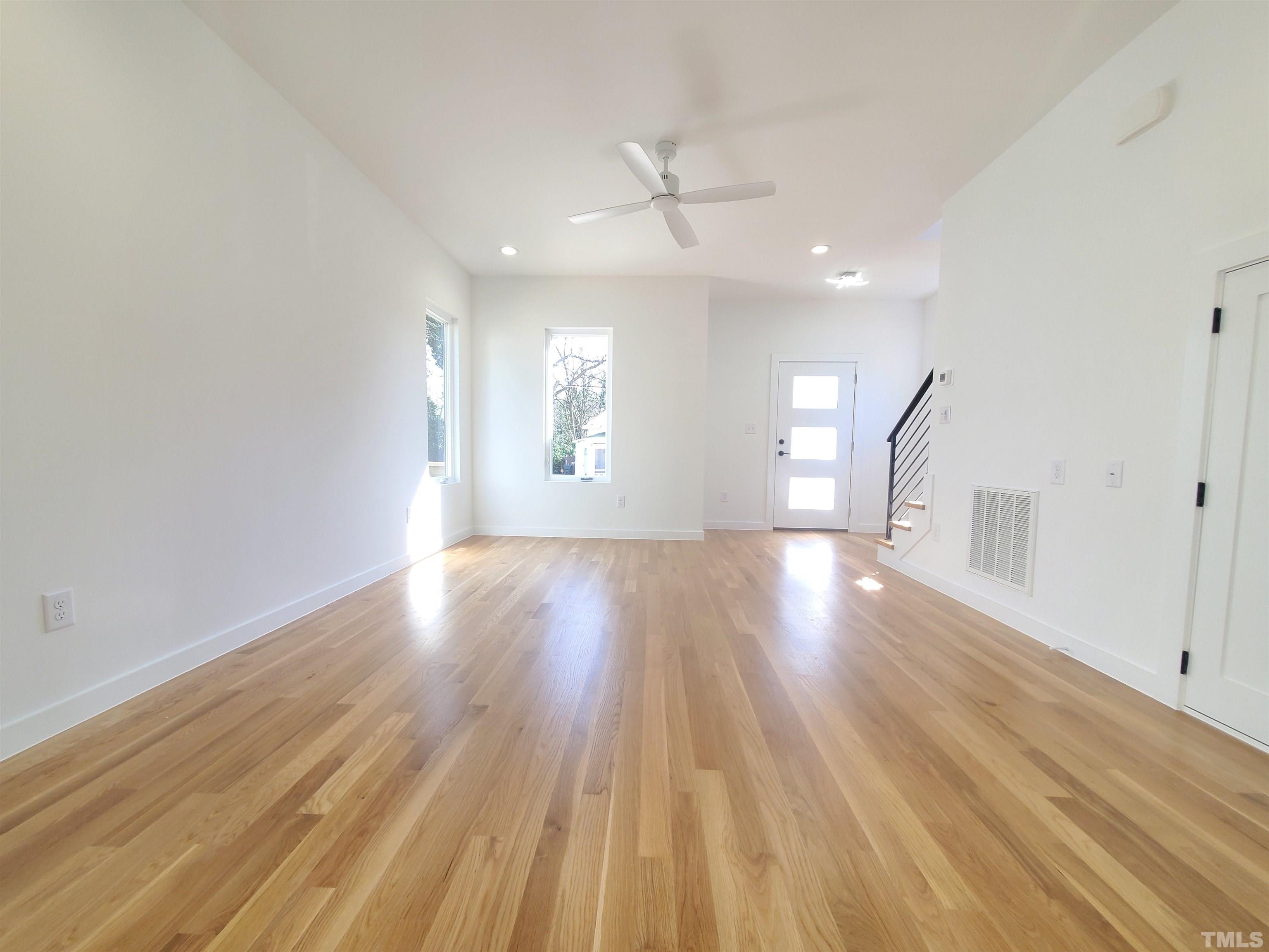 221 Bledsoe Avenue Raleigh, NC 27601 - Photo 2 of 28 a view of an empty room with wooden floor and a window