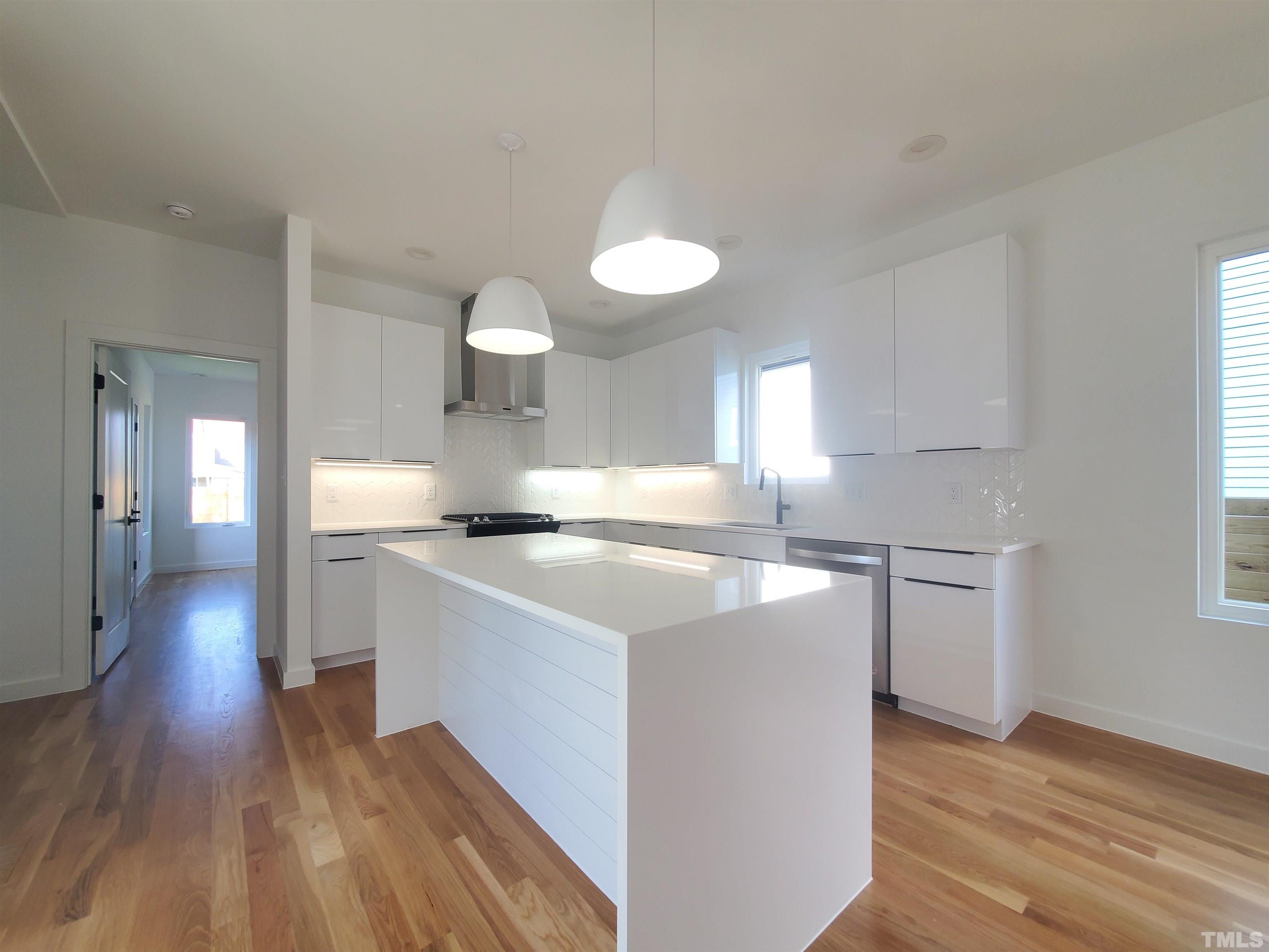 221 Bledsoe Avenue Raleigh, NC 27601 - Photo 4 of 28 a kitchen with a stove and wooden floor