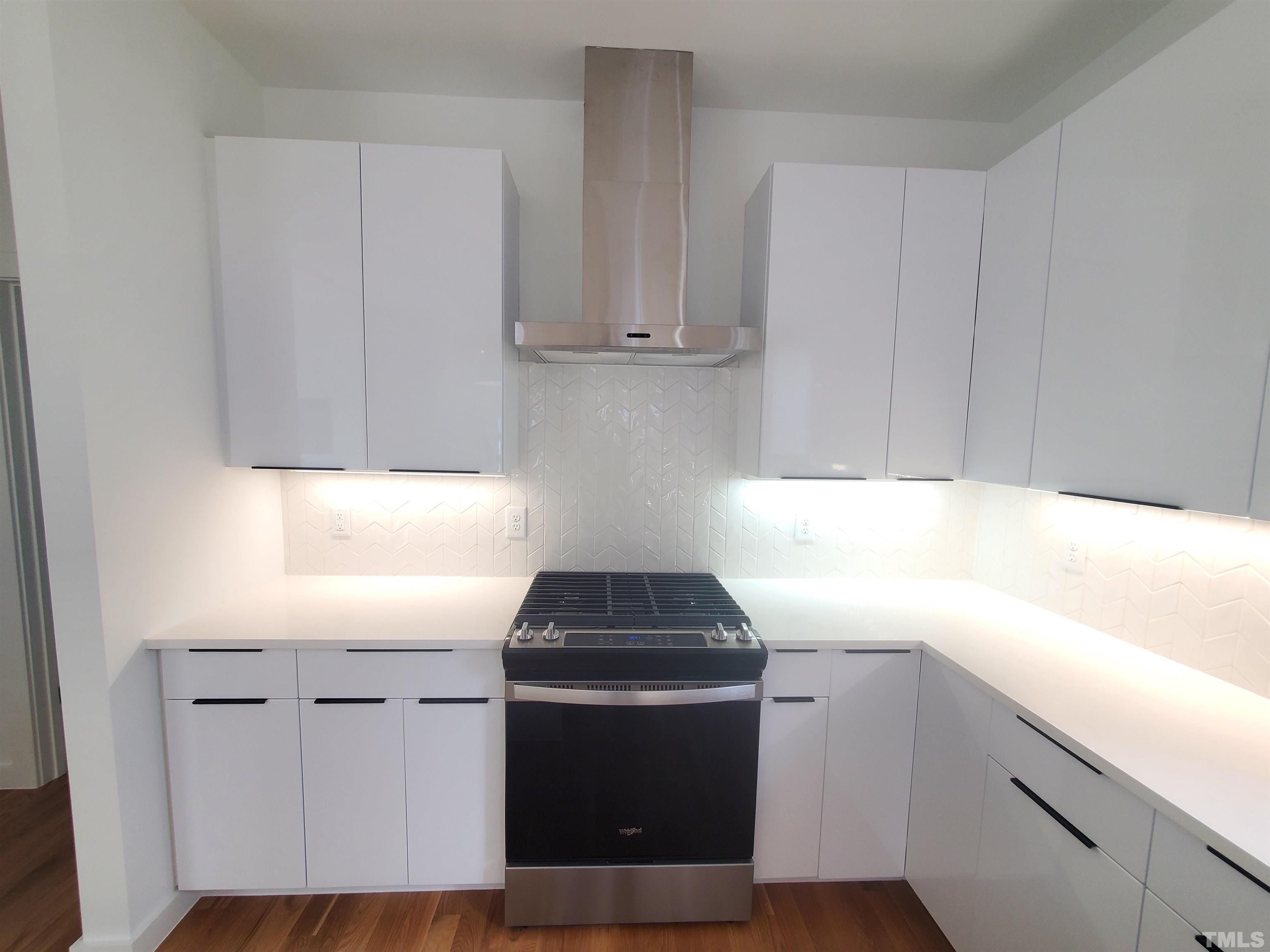 221 Bledsoe Avenue Raleigh, NC 27601 - Photo 6 of 28 a kitchen with a sink and a stove top oven