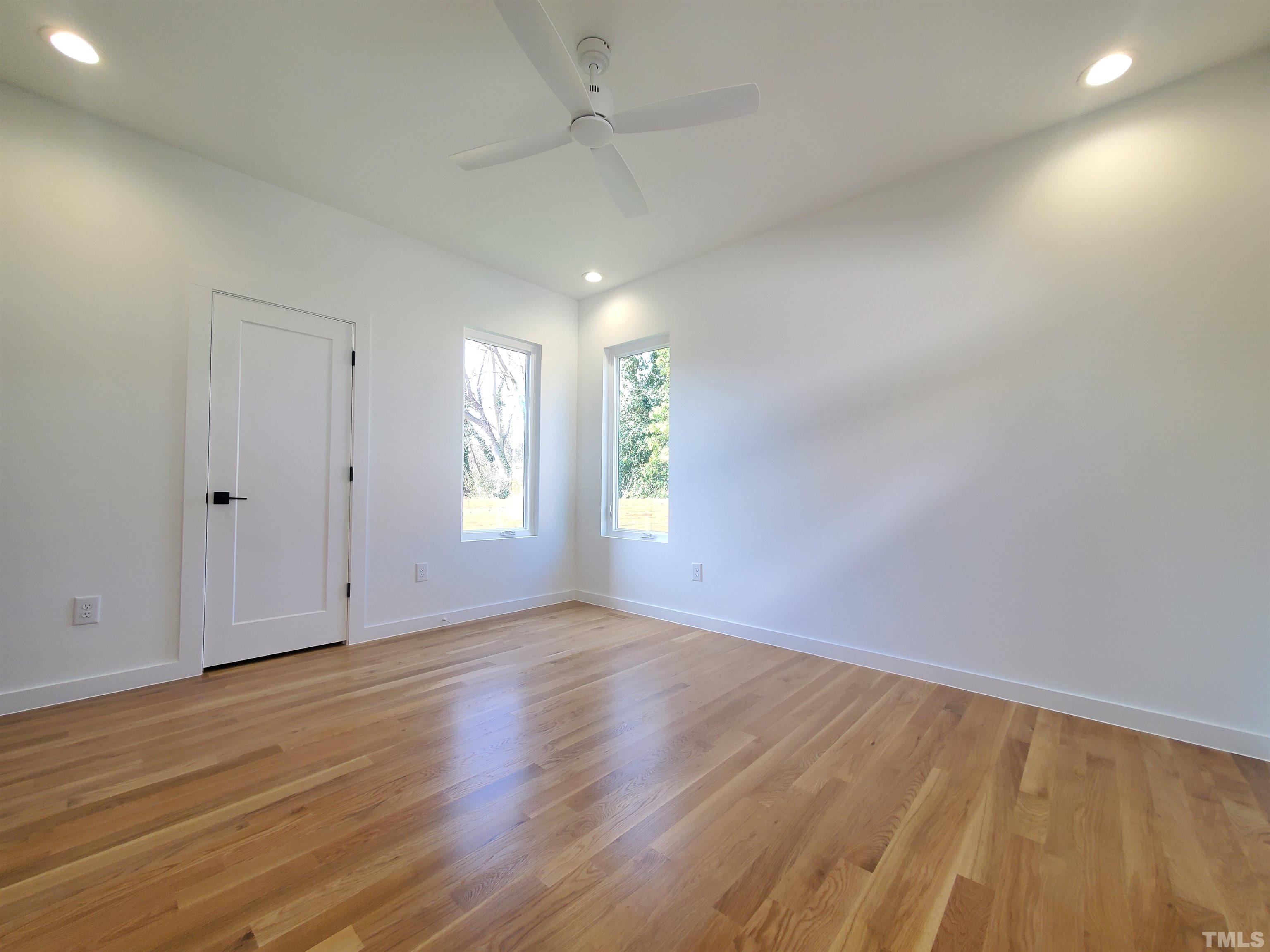 221 Bledsoe Avenue Raleigh, NC 27601 - Photo 9 of 28 an empty room with wooden floor and windows