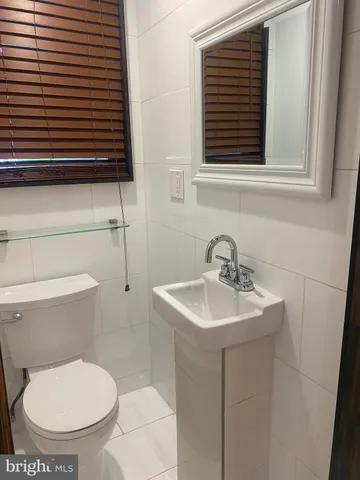 a bathroom with a toilet a sink and a window