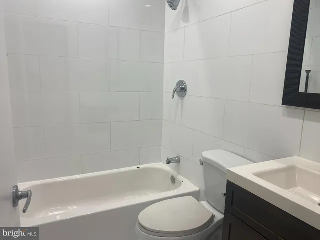 a bathroom with a sink toilet a mirror and vanity