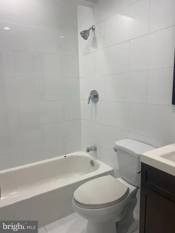 a bathroom with a white bath tub and a shower