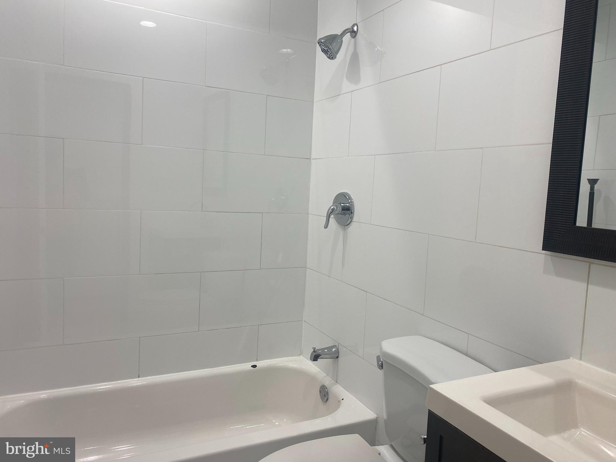 2641 Tulip Street Philadelphia, PA 19125 - Photo 23 of 37 a bathroom with a white bath tub and a shower