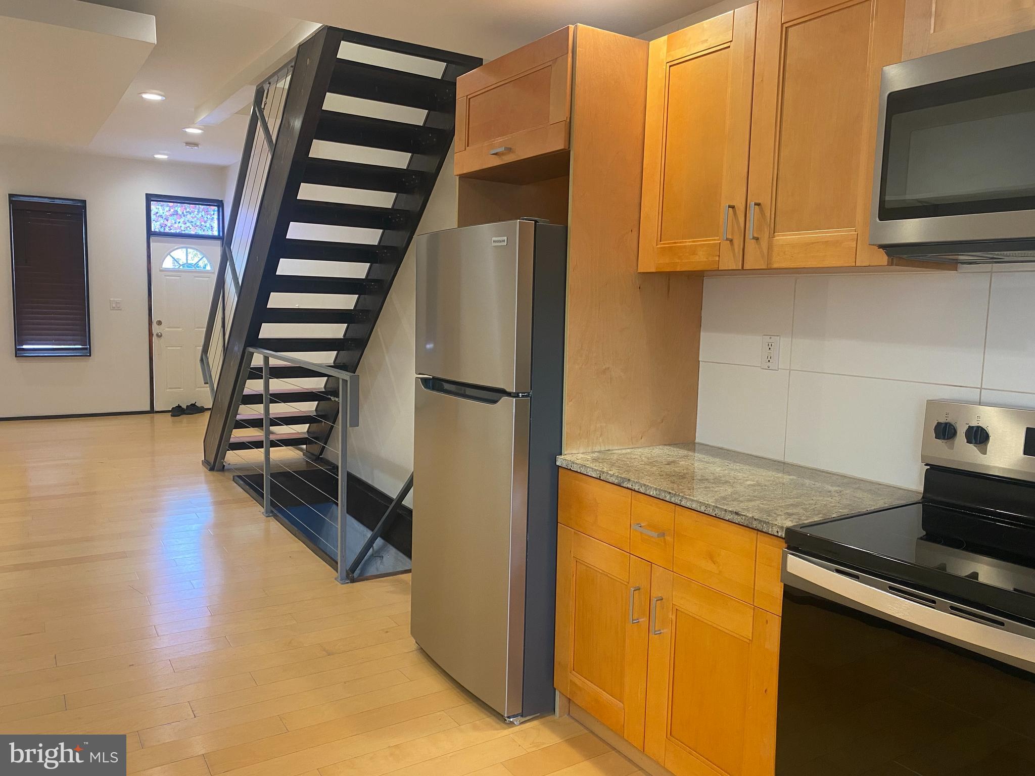 2641 Tulip Street Philadelphia, PA 19125 - Photo 10 of 37 a kitchen with stainless steel appliances granite countertop a refrigerator and a stove top oven