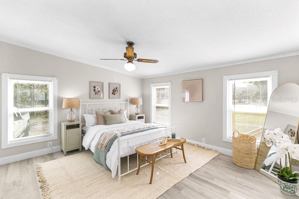 18137 Hollister Road Orlando, FL 32820 - Photo 12 of 27 a bedroom with a bed and wooden floor
