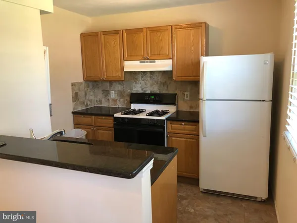 a bathroom with a bathtub sink and mirror
